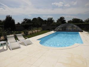 a swimming pool with two chairs and a glass dome at Maison de caractère avec piscine chauffée, étang privé et proche forêt, à 90 min de Paris - FR-1-581-48 in La Chapelle-Fortin