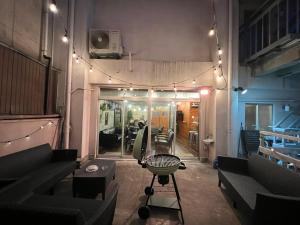 a room with couches and a table and lights at HOSTEL OE in Yoshinogawa