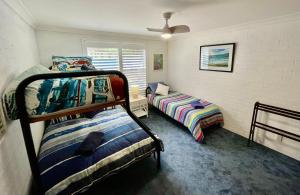 a bedroom with two bunk beds and a window at Aqua Dolce Beach House in Copacabana