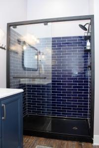 a bathroom with a shower with blue tiles at Bischoff Inn - Former 1870 Furniture Factory Now 5 Room Boutique Hotel 