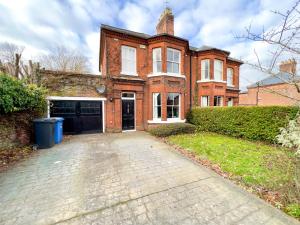a brick house with a driveway in front of it at Stylish 4 bed house with parking in central Norwich in Norwich