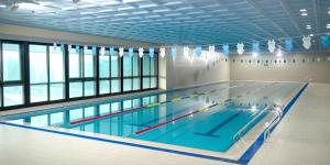 a large swimming pool in a building at Interburgo Hotel Wonju in Wonju