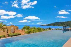 a swimming pool in a villa with a view of the ocean at Aqua Vista in Airlie Beach