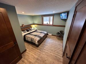 a bedroom with a bed and a television in it at Beautiful Suite In Cranbrook! in Cranbrook