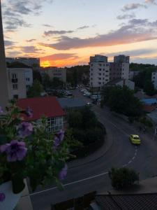 a view of a street with a sunset in a city at Cozy Apartment - near Airport and Palas Mall in Iaşi