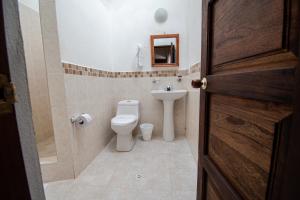a bathroom with a toilet and a sink at Hotel Villa Luna in Villa de Leyva