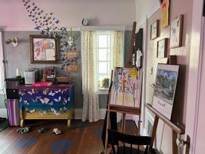 a room with a easel and a painting on the floor at Harbinson House in Sacramento