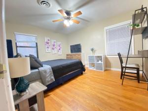 a bedroom with a bed and a ceiling fan at WHOLE Family - Edison in Sacramento