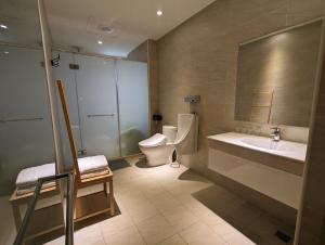 a bathroom with a toilet and a sink at Kun living in Taitung City +18 photos