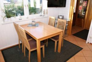 a wooden table and chairs in a dining room at Blockhaus mit schoenem Grundstueck in Damp