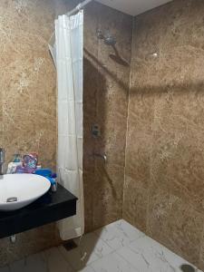 a bathroom with a shower and a sink at Luxury Apartemen Grand Lagoon Sungkono Surabaya in Dukuhpakis