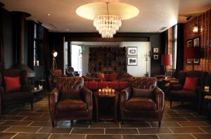 a lobby with a couch and chairs and a chandelier at Hotel Du Vin Newcastle in Newcastle upon Tyne