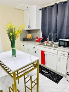 a kitchen with a vase of flowers on a table at Southern Comfort Retreat in Macon