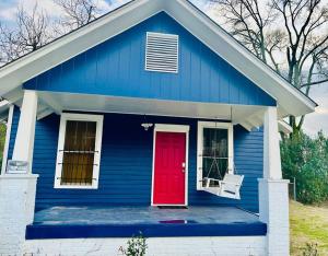 a blue house with a red door at Southern Comfort Retreat in Macon