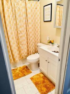 a bathroom with a toilet and a sink at Southern Comfort Retreat in Macon