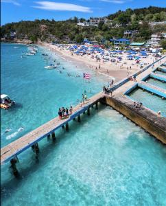 an aerial view of a beach with people in the water at Villa near Crash Boat Beach Aguadilla, PR 2nd flr in Camaceyes