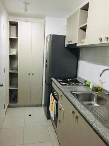 małą kuchnię ze zlewem i kuchenką w obiekcie apartamento nuevo comodo 4 camas w mieście Viña del Mar