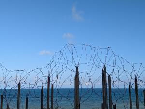 a barbed wire fence in front of a body of water at Kun living in Taitung City
