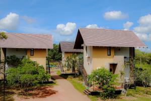 a row of houses with a pathway in front at Lolu Village Resort in Anuradhapura