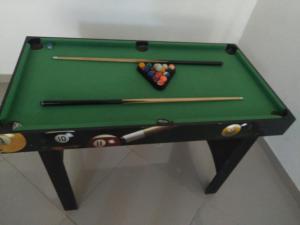 a green pool table with cue balls and chopsticks at VILLA BRAULIO in Rozo