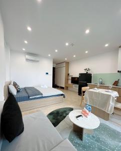 a bedroom with a bed and a living room at hamy’s house- studio vinhomes d’capital apartment 119 tran duy hung in Hanoi