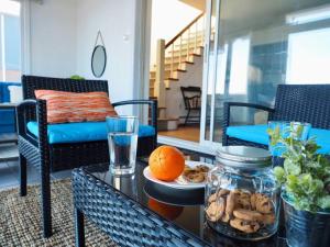 a living room with a table with an orange on it at Casa al Mare Beachfront Retreat King Bed Near Yale in East Haven