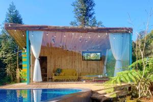 a pergola over a pool with a house at Thanh Truc Villa & Flower in Sa Pa