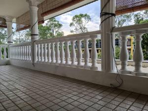 a balcony with white railings on a house at Cosy and family friendly house in Sungai Petani
