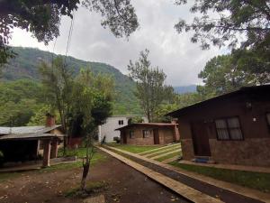 uma vista para uma casa com montanhas ao fundo em Hotel del Bosque em Panajachel