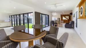 a living room with a table and chairs at Magical holiday home - Welsby Pde, Bongaree in Bongaree