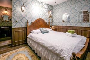 a bedroom with a large bed with blue wallpaper at Bias K-girl Guesthouse Women only 女性專用 in Seoul