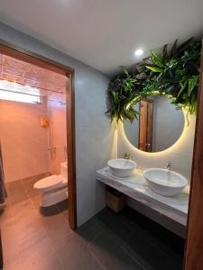 a bathroom with two sinks and a mirror at En nho Homestay SaPa in Sapa