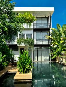 una casa con piscina frente a un edificio en Tushita Villa, Pool & Gardens, en Siem Reap