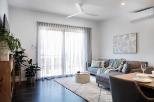 a living room with a couch and a table at Little Jem in Daylesford