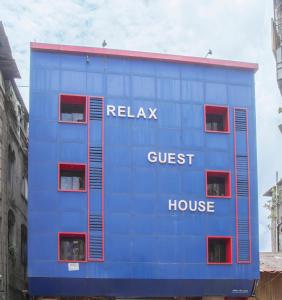 a blue building with the words relax guest house at RELAX GUEST HOUSE in Mumbai