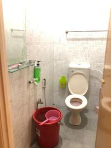 a bathroom with a toilet and a bucket at Homestay Seri Hampar, Pendang in Pendang