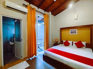 um quarto com uma cama grande e uma janela grande em Lake Reach Hotel em Kandy