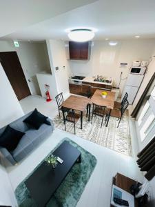 a living room with a couch and a table at 羽田ハウスⅠ _ Haneda House Ⅰ in Tokyo