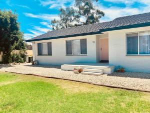 a blue and white house with a grass yard at COD & C0 Tocumwal in Tocumwal