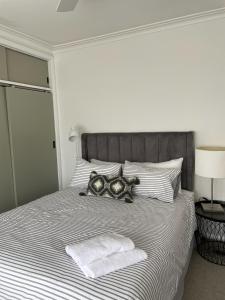 a bedroom with a bed with two towels on it at COD & C0 Tocumwal in Tocumwal
