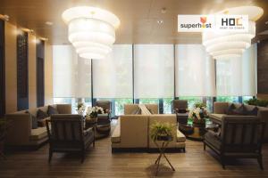 a lobby with couches and chairs in a building at Modern 2-Bedroom Condo with Pool in Chiang Mai
