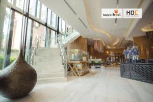 a lobby with a large vase in the middle of a building at Modern 2-Bedroom Condo with Pool in Chiang Mai