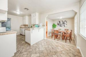 a kitchen and dining room with a table and chairs at Renovated home minutes from Fresno State / Airport in Fresno