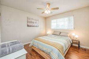 a bedroom with a bed and a ceiling fan at Renovated home minutes from Fresno State / Airport in Fresno