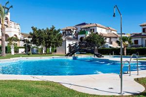 a large swimming pool in a yard with houses at Casa Manuela in Vera