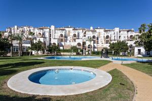 a large apartment building with a large swimming pool at Casa Manuela in Vera +40 photos