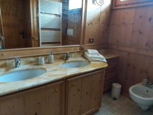 Baño con 2 lavabos y espejo en Ca' Myosotis, en Cortina dʼAmpezzo