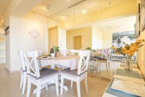 a dining room with a white table and chairs at Marbella Este Next Marriott and Nikki B - Happy Rentals in Marbella