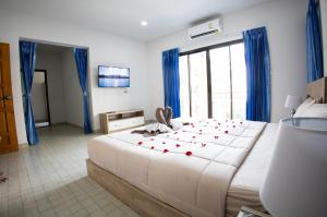a bedroom with a large bed with red hearts on it at Grand View Premium in Patong Beach