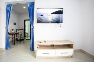 a living room with a tv on a wall at Grand View Premium in Patong Beach